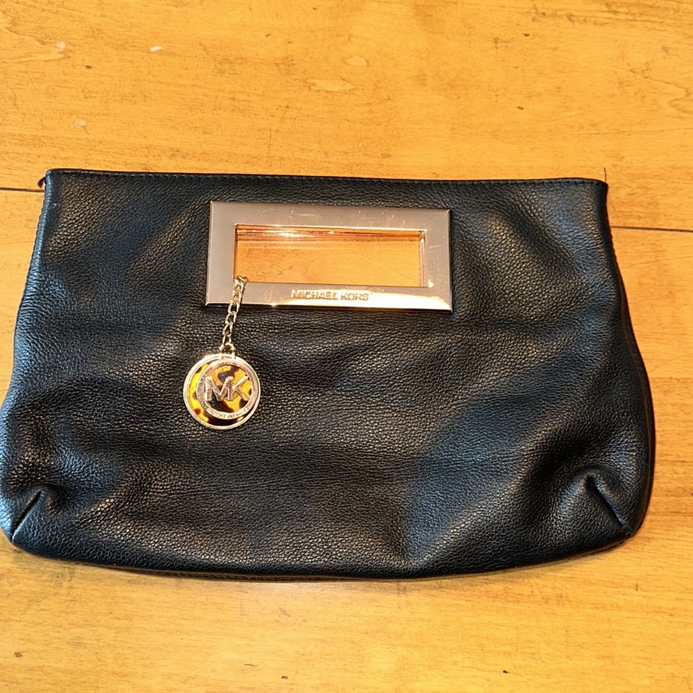 Excellent condition Michael Kors, black leather clutch with rose gold accent